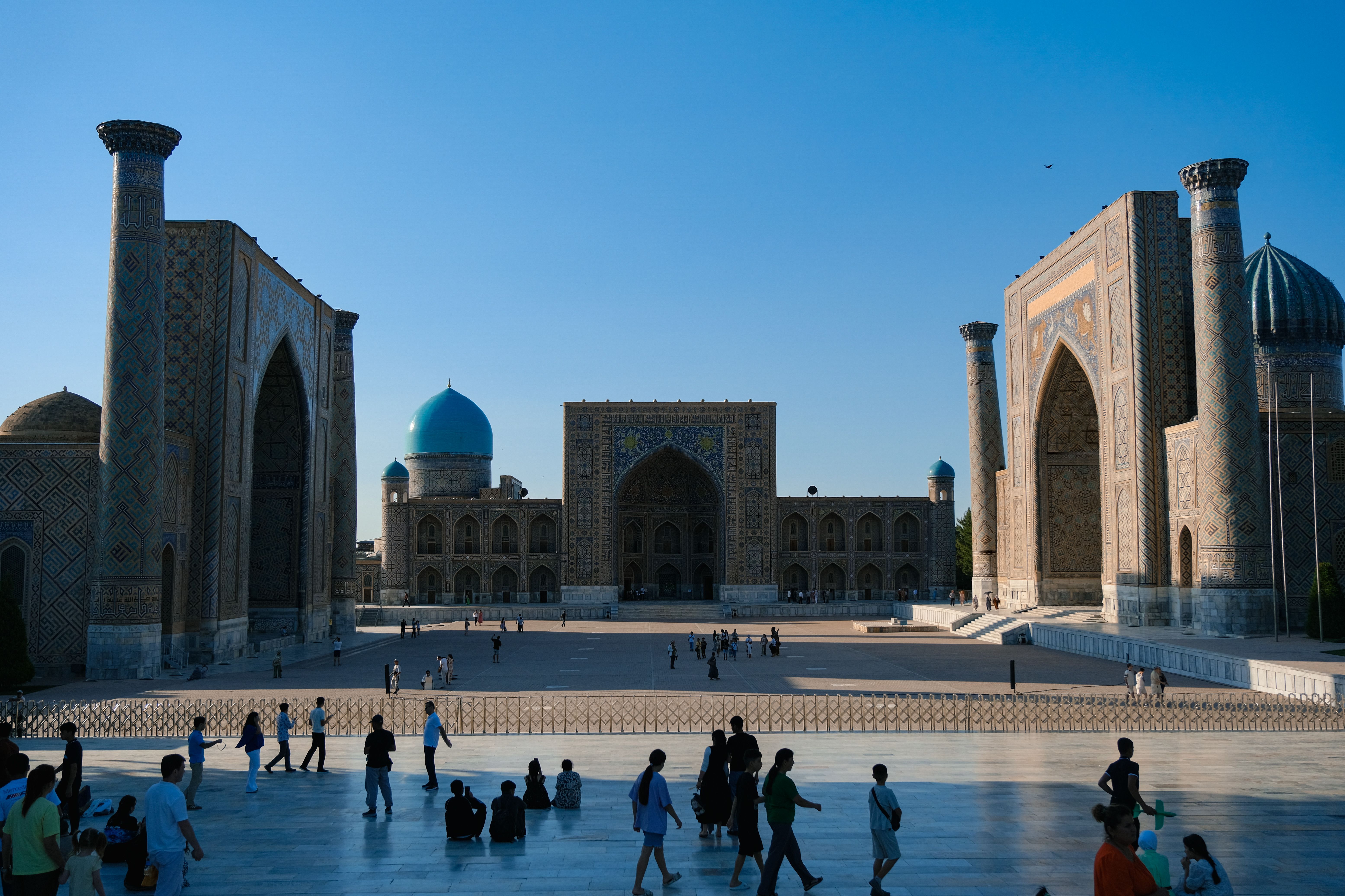Historic square with blue-domed Islamic architecture